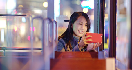 Canvas Print - Woman take photo on tram at night