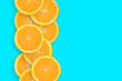 Row of an orange citrus slices on bright blue background