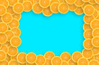 Frame of an orange citrus slices on bright blue background