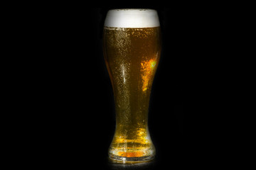 glass of beer on dark background