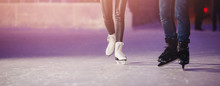 Closeup Of Winter Skates On Transparent Ice Rink Night. Couple In Love