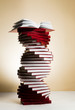 A spiral of stacks of books in the form of DNA and an open textbook at the top.