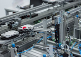 Fototapeta  - Gripper picks up the product from automated car which is on the manufacturing line in a smart factory. Industry 4.0 concept; artificial intelligence in manufacturing.