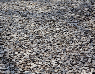 Sticker - Texture of gray gravel. Grey stony floor. A wall of gray gravel. Stones small and medium-sized. Sharp edges of the stones. Sand and stones on the floor. The land is covered with stones