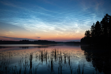 Wall Mural - night shining clouds over lake in finland