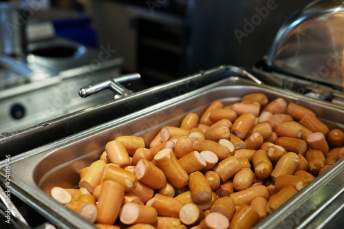 Fotografie, Obraz a lot of cooked sausages on plates restaurant cuisines