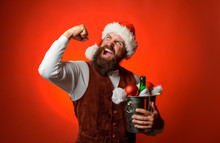 Winter, Christmas, New Year. Celebration, Alcohol, Holidays Concept - Happy Man Or Waiter With Ice Bucket With Bottle Champagne At Party. Christmas Or New Year Preparation. Santa Man Holds Wine Cooler