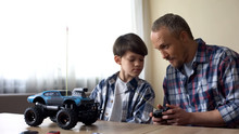 Father And Son Operating Radio-controlled Car, Leisure Activity, Birthday Gift