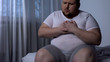 © motortion - Overweight man suffering from chest pain, high blood pressure, cholesterol level