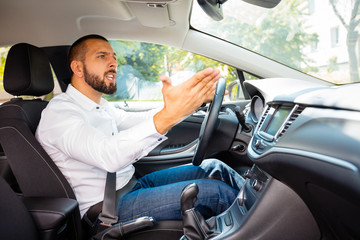 Upset businessman driving a car