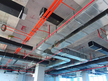 Air Condition Duct And Other Services Above Ceiling Level Coordinated And Installed By Construction Workers  At The Construction Site 