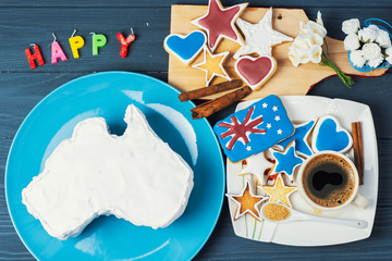 vanilla cream cake in a shape of the Australian continent on blue background 