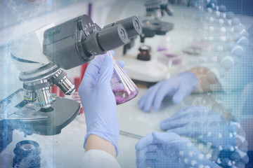 two young laboratory scientists working at lab with test tubes and microscope, test or research in c