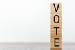 © raquel - Vote written on wooden cubes against white background