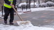 © CreativeSuburb - Man with snow shovel cleans sidewalks in winter.