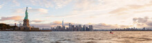 Panoramic View Of The Statue Of Liberty And Downtown Manhattan In The Background During A Vibrant Cloudy Sunrise. Taken In Jersey City, New Jersey, United States.