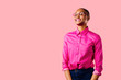 © Carlos David - Portrait of a young smiling woman in pink shirt, isolated on pink studio background