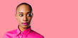 © Carlos David - Portrait of a young woman in pink shirt looking to the side, isolated on pink studio background
