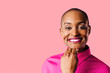 © Carlos David - Portrait of a young woman in pink shirt smiling at camera, isolated on pink studio background