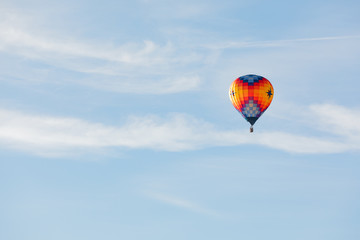 Hot air balloon flying over blue sky