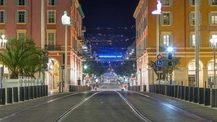 Canvas Print - Night cityscape with moving tram on Massena Square in downtown timelapse