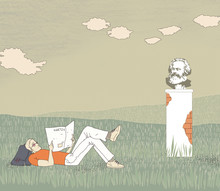 German Socialism. An Unemployed Young Man Lying On The Grass Reading A Newspaper. Backpack Under His Head. Bust Of Karl Marx On The Background Of A Summer Green Field Under The Clouds.