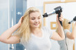 © anetlanda - Blonde woman using hair dryer