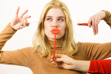 Wall Mural - Woman applying lipstick or lip gloss