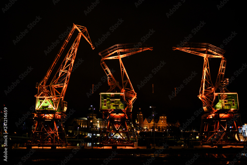 Obraz na płótnie Highlighted cranes in Szczecin, a city monument. Highlighted cranes in Szczecin, a city monument. w salonie