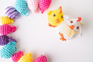 A yellow easter chicken and a hen with colorful Easter eggs, crocheted