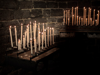 Church candles, burning in the dark. Prayers.