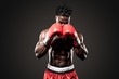 © Paul - Muscular African American Black male sweaty boxer covers his head as he comes  towards the camera  with dramatic lighting with a black background