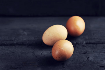 Wall Mural - chicken eggs on a black background