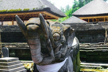 Very old elephant shape stone sculpture covered with moss and lichens in Bali, Indonesia