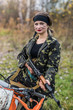 © RomanR - Young woman in camouflage clothes with gun