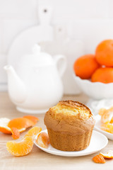 Muffin with tangerines closeup on white background. Sweet delicious homemade baking. . White background. Wooden background.