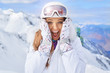 © ZoomTeam - Close up portrait of a woman at a snow ski center.