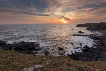 Wall Mural - Seascape during sunrise. Beautiful natural seascape. Sea sunrise at the Black Sea coast. Magnificent sunrise with clouds and fire sun at the beginning of April.