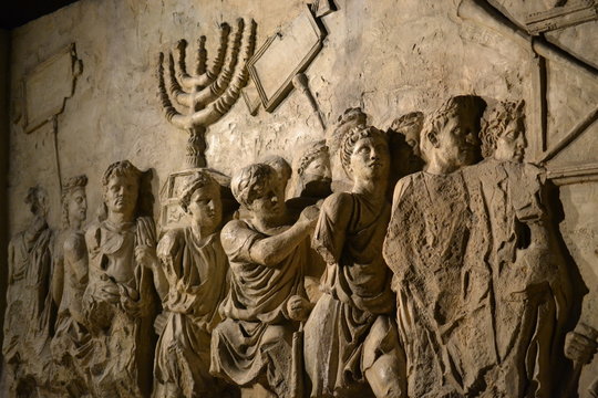 wall relief on arch of titus depicting menorah taken from temple in jerusalem in 70 ad - israel hist