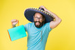 © be free - Buy souvenir from travel. Man wear sombrero hat shopping yellow background. Guy with beard happy in sombrero. Souvenir gift from abroad. Man hold shopping bag. Buy souvenir for friends and family