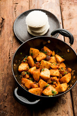 Canvas Print - Masala fried Idlies or Idli fry - south indian Snack made using with leftover idly served with tomato ketchup. selective focus