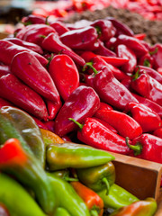 Sticker - Red, orange and green pointed sweet peppers for sale in the fram shop local market.