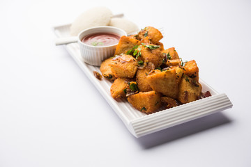 Canvas Print - Masala fried Idlies or Idli fry - south indian Snack made using with leftover idly served with tomato ketchup. selective focus