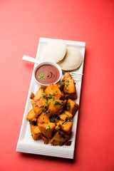 Canvas Print - Masala fried Idlies or Idli fry - south indian Snack made using with leftover idly served with tomato ketchup. selective focus