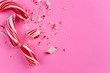 broken candy cane on pink background. close-up photo