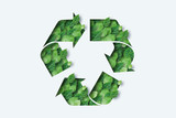 Fototapeta  - Recycling icon made from green leaves. Light background. The concept of recycling, non-waste production, eco-plastic, eco fuel.