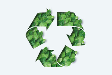 recycling icon made from green leaves. light background. the concept of recycling, non-waste product