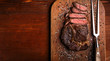 tasty and fresh, very juicy ribbey steak of marbled beef, on a wooden table.