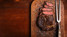 Tasty And Fresh, Very Juicy Ribbey Steak Of Marbled Beef, On A Wooden Table.