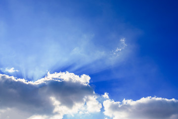 Wall Mural - Beautiful beam of light and the fluffy clouds. Blue sky with sun rays